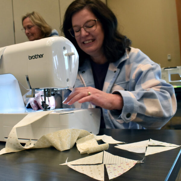 Member Sews Blocks during Quilting Workshop with Green Light Quilts
